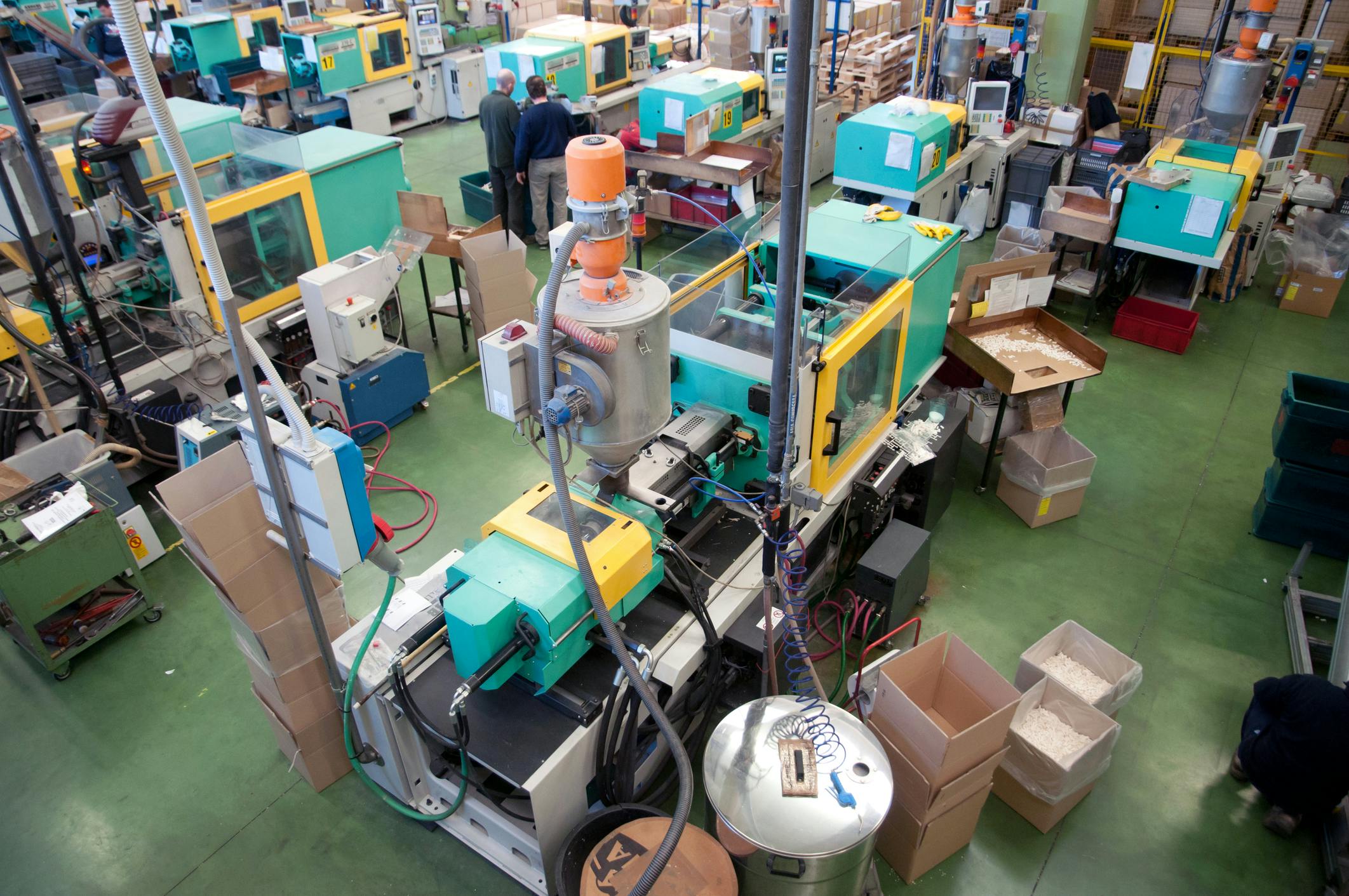 Injection molding machines on a shop floor.