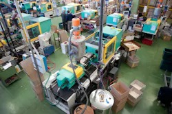 Injection molding machines on a shop floor.