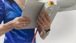 The E-Device integrates physical safety controls, including an emergency-stop button and a three-position enabling switch.