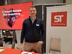 Aleksandr Kharazov, regional sales manager for ST BlowMoulding USA, at his company's stand in the exhibit area.
