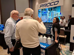 At the Proco Machinery stand, founder John McCormick (left) and daughter Katie McCormick (right) chat with a visitor.