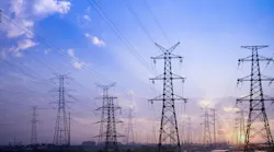 Image shows high voltage power lines against a twilight sky