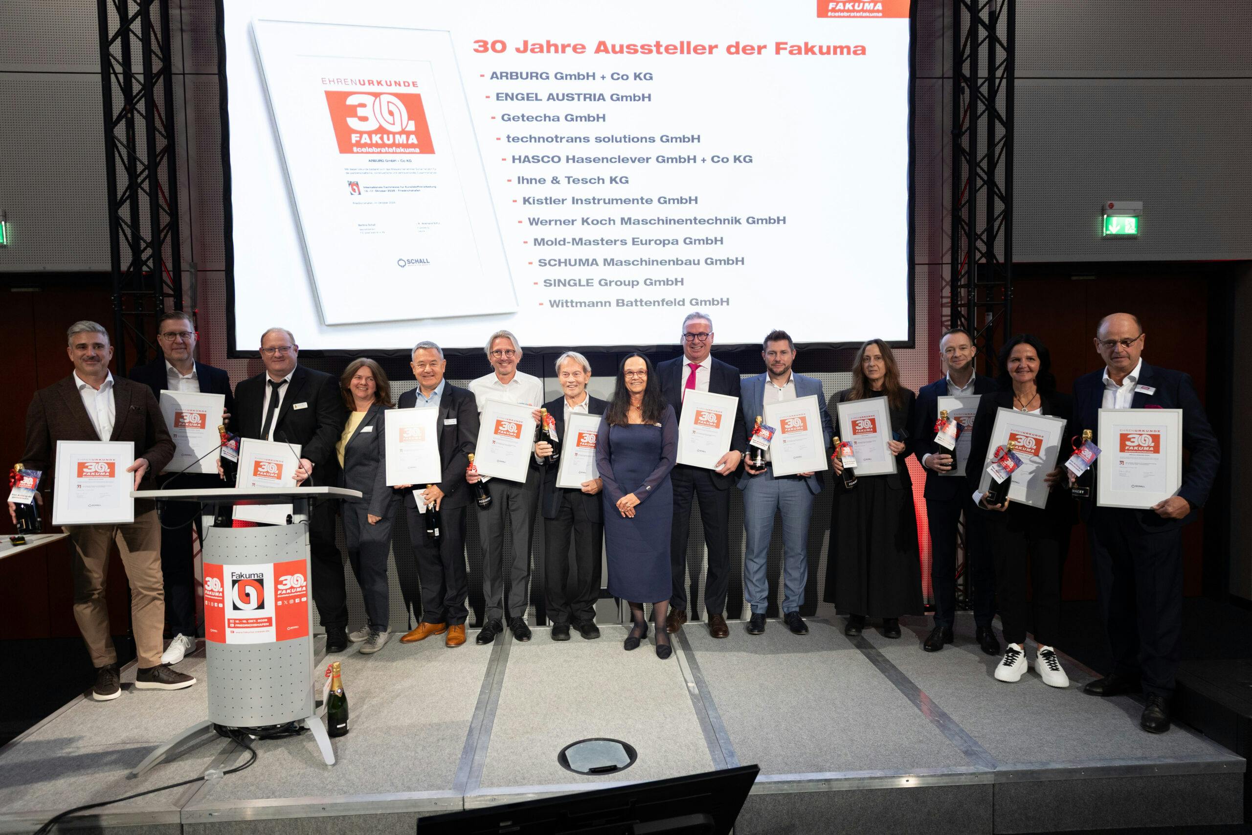 Representatives of 12 companies that have participated in Fakuma since its inauguration in 1981 holding certificates