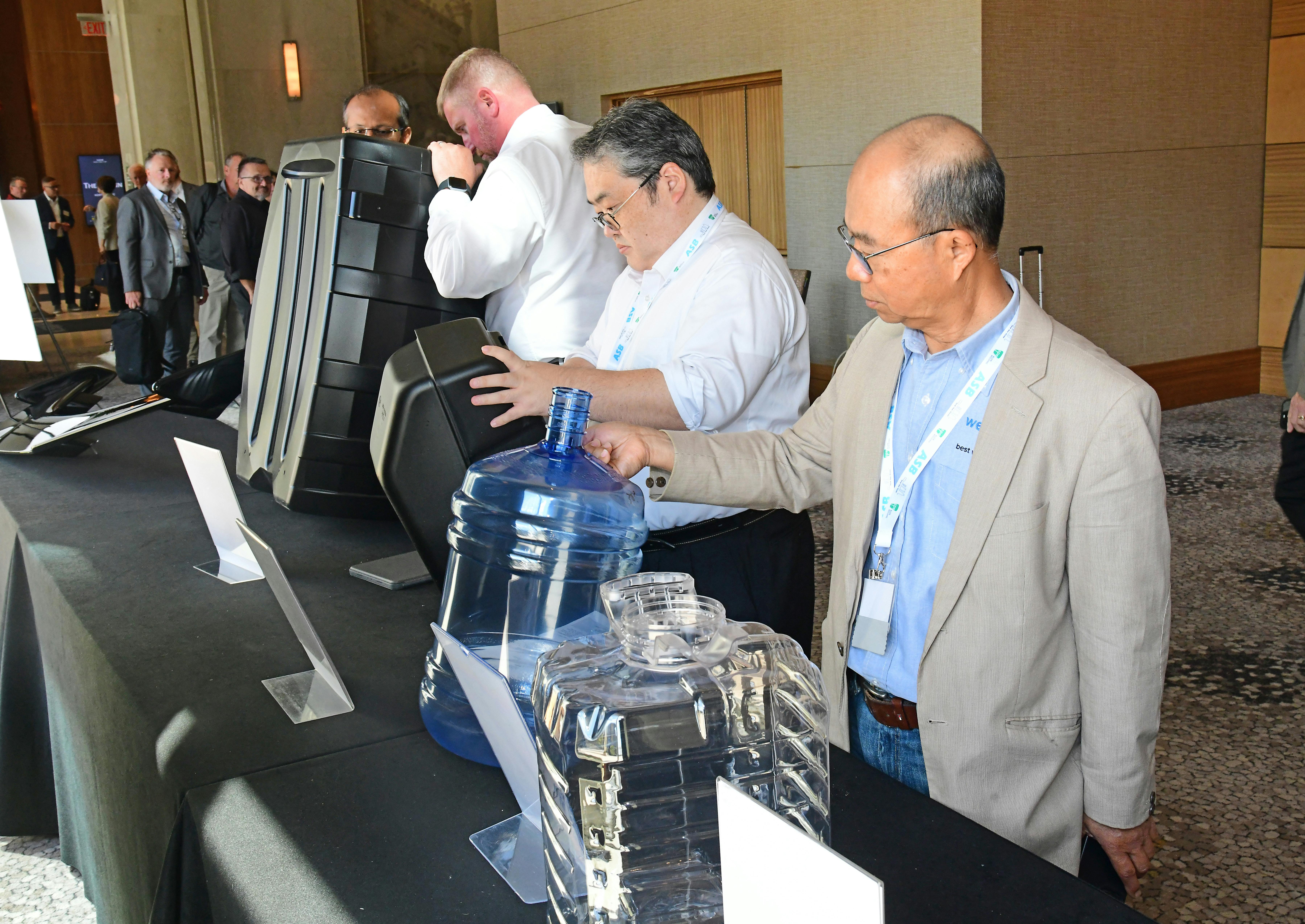 ABC attendees examine the contenders in the 2026 Lewis E. Ferguson Blow Molded Parts Competition.