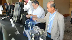 ABC attendees examine the contenders in the 2026 Lewis E. Ferguson Blow Molded Parts Competition.