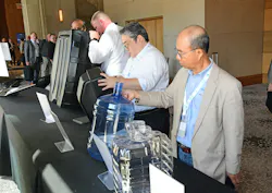 ABC attendees examine the contenders in the 2026 Lewis E. Ferguson Blow Molded Parts Competition.